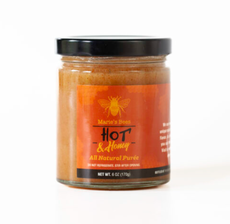 Hot Creamed honey in a jar with our Marie's Bees logo on it. 