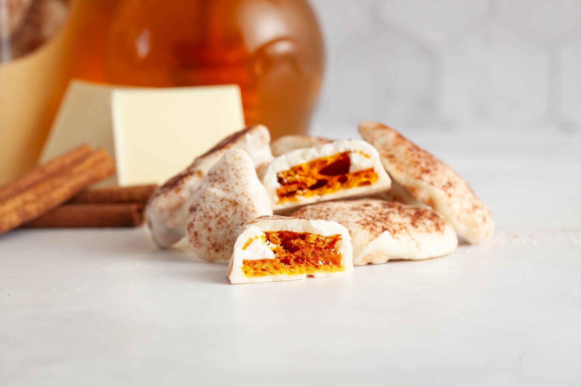 Lemon Cinnamon Honeycomb is stacked on itself with one piece cut in half to show the airy candy. 